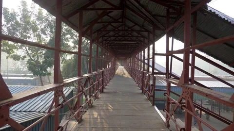 Walking along an abandoned rusty bridge at sunrise Video stock 153123499