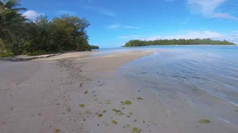 Walking along beach sandy side look out to calm relax turquoise ocean lagoon ato Stock Footage 253461620