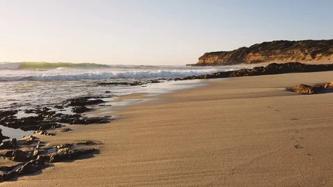 Walking along a beach with waves washing into the shore in Australia. Stock Footage 101768684