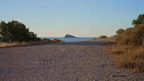 Walking along a coastal path at sunset near a seaside location with a view .. Stock Footage 340190662