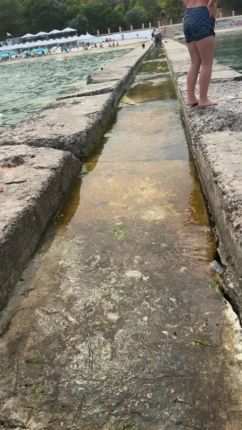 Walking along concrete pier at seaside Stock Footage 339730281