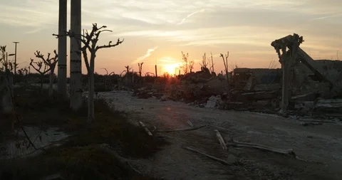 Walking along destroyed and abandoned city, sun at horizon. Demolished cityscape 스톡 동영상 126339166