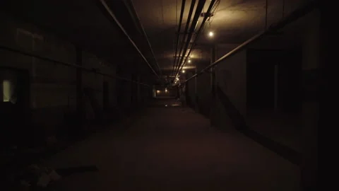 Walking along a dimly lit basement or subway Stock Footage 132356007