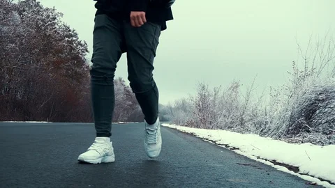 Walking along an empty road Stock Footage 99939024