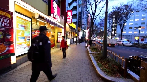 Walking along the evening street of Tokyo. Santa Clause with advert near shop. Stock Footage