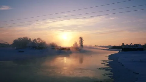 Walking along misty river in winter village Stock Footage 72644010