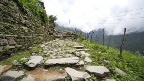 Walking along mountain hillside path in the clouds Stock Footage 91434358