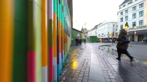 Walking along a multi colored fence on a rainy day in Copenhagen Stock-Footage 44875068