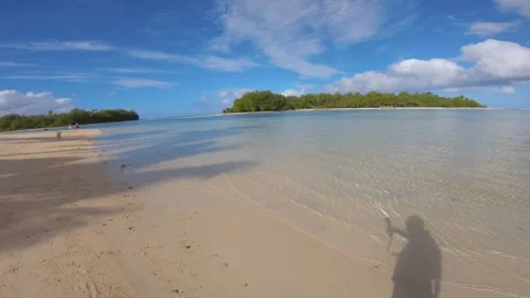 Walking along Muri beach side look out to calm relax turquoise ocean lagoon atol Stock Footage 253461070