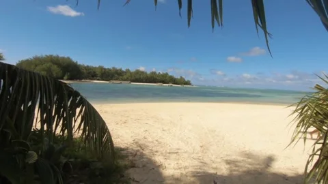 Walking along narrow path way to open landscape view towards Muri beach on sandy Stock Footage 245442699