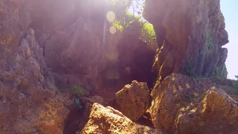 Walking along the narrow rocky path way by cliff on dirt trail road with green g Stock Footage 279140809