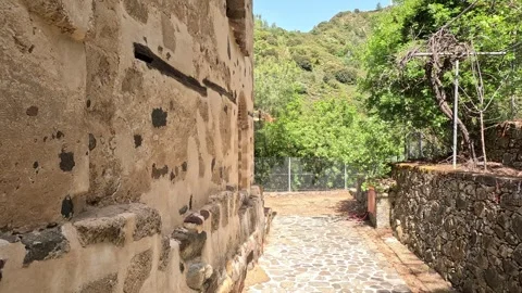 Walking along old anthient wall building in the mountains Stock Footage 240647043