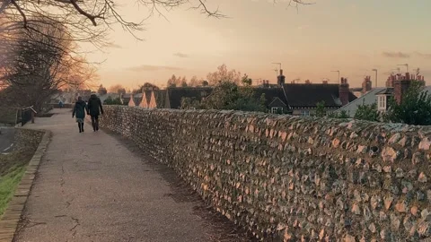 Walking along the old Chichester city walls in the evening light  Stock Footage 235927853