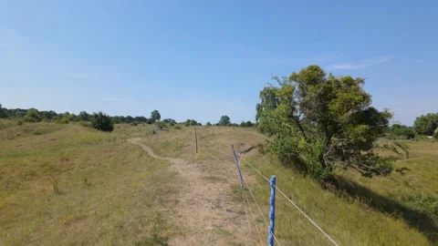 Walking along a path looking out at the open expanse - Barnack Hills and Holes Stock Footage 340283243