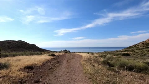 Walking along a path towards the sea Stock Footage 268901465