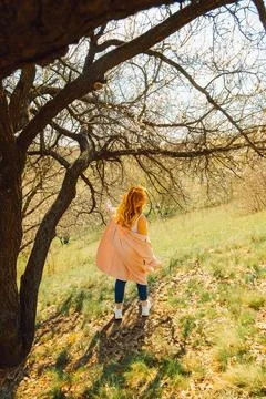 Walking along  path under trees with blossoms on  sunny day in spring.  perso Stock Photos