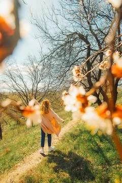 Walking along  path under trees with blossoms on  sunny day in spring.  perso Stock-Fotos