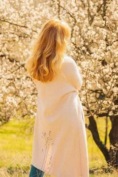 Walking along  path under trees with blossoms on  sunny day in spring.  perso Stock Photos