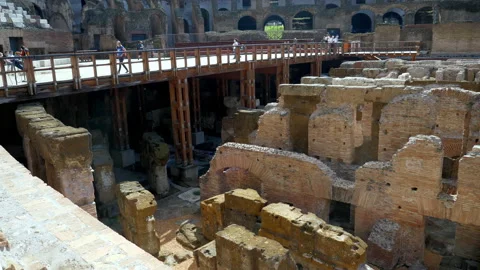 Walking along the paths and corridors inside the Colisseum while overlooking Stock Footage 147938583