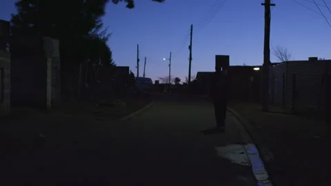 Walking along the road in the dark Stock Footage 242010978