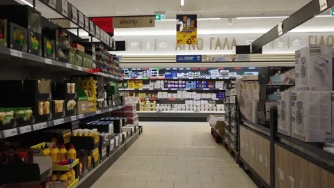 Walking along the rows with products in a large supermarket. Stock Footage 135569646