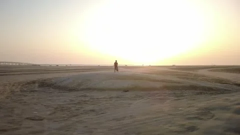 Walking Along Sandy Beach at Sunrise in Al Khobar Stock Footage 336571941