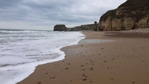 Walking Along the Seashore With Rocks and People in the Distance (Marsden Beach) Stock Footage 246943075