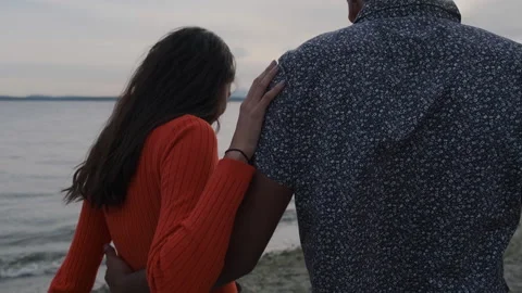 Walking along the serene beach at sunset with a loved one Stock Footage 312708624