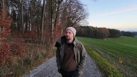 Walking along the tree line, with drone in Front. 5Sek. Stock Footage 322804880