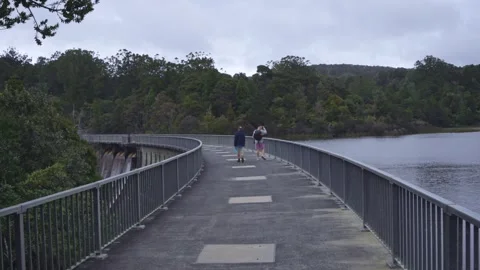 Walking along Waitakere Dam in the Waitakere ranges, Auckland, New Zealand Stock-Footage 287196853