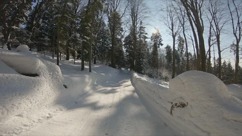 Walking along the winter snowy mountain road in forest, first person view Stock Footage 254485293