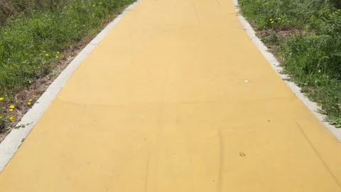 Walking along yellow path first person pov in slow motion Video stock 132012984