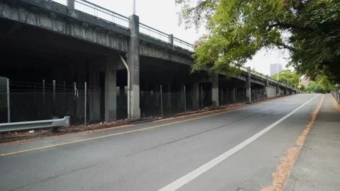 Walking alongside a road and bridge Stock Footage 137754095