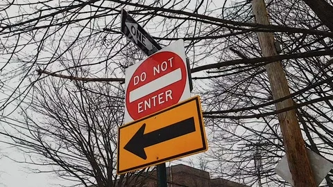 Walking Up To And Around A Do Not Enter, One Way, Left Turn, And Stop Stock Footage 112597662