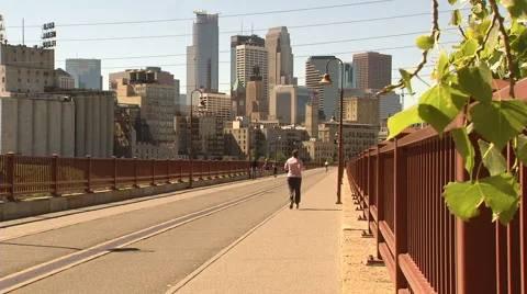 Walking and Biking on Stone Arch Bridge Stock Footage 42765133