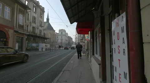 Walking and driving cars close to the Sacred Heart Cathedral in Sarajevo Stock Footage 59794636