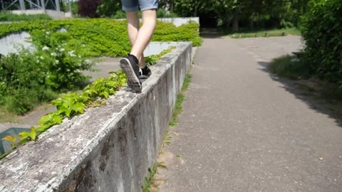 Walking and jumping off a pavement Stock Footage 142931623