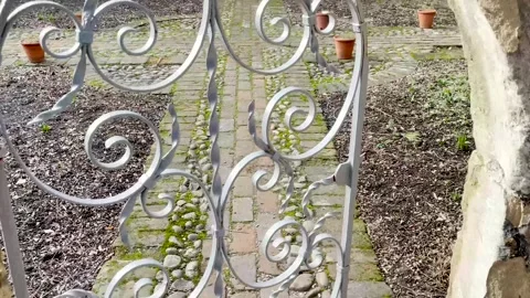 Walking and opening an ancient stone archway door with open white door Stock Footage 263072624