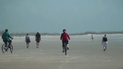 Walking and riding bikes on the beach Stock Footage 37672071