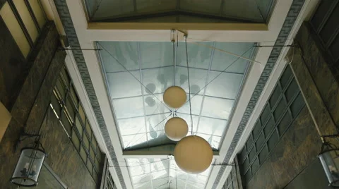 Walking in an arcade of a neoclassical modern building looking up Stock-Footage 60431372
