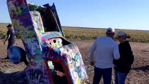 Walking around the Cadillac Ranch with close-up of paint layers and tail fins Vídeo Stock 169262802