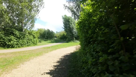Walking around the corner to a long, straight, bright path ahead Stock Footage 339799158