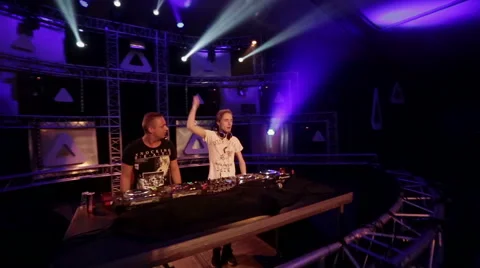 Walking around two DJ's on a big stage Stock Footage 54998247