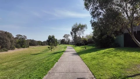 Walking backward of a concrete footpath at Werribee River Trail Stock Footage 295330600