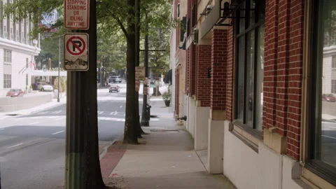 Walking Backwards Medium Shot Down Atlanta Sidewalk By Brick Building 4K 48F Stock Footage 270447724