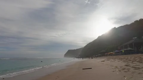 Walking on Bali Beach at Sunset – 4K Footage with Golden Light and Ocean Waves Stock Footage 312509345