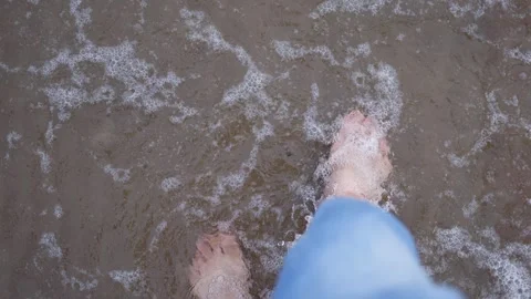 Walking barefoot on the beach by the sea Stock Footage 288079059