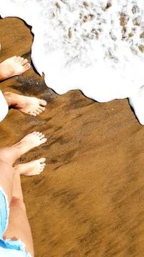 Walking on the beach barefoot Stock Photos