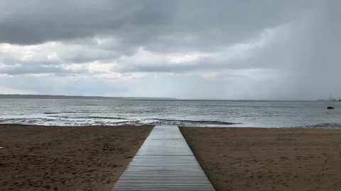 Walking on a Beach Bridge as Rain Starts Stock-Footage 154533692