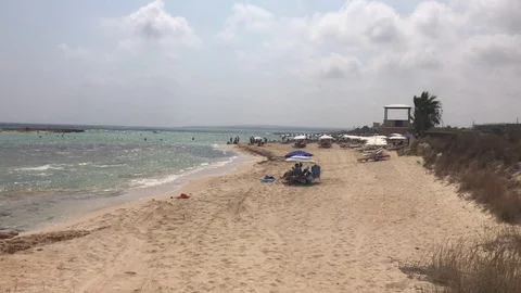 Walking at the beach with a cloudy sky in Ayia Napa Stock Footage 95035137